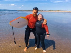 Surf instructor teaching diverse group including students with different abilities on Rossnowlagh Beach, demonstrating our commitment to inclusive surfing